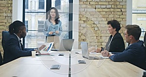 Beautiful young confident CEO leading business meeting in office. Portrait of smiling gorgeous Caucasian woman