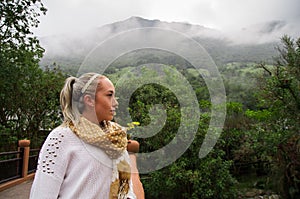 Beautiful young contemplative woman in a forest