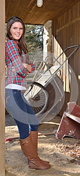 Beautiful young country girl on farm outdoors