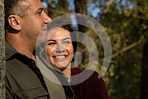 Beautiful young couple in autumn forest on a sunny day