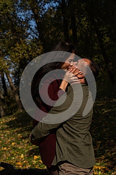 Beautiful young couple in autumn forest on a sunny day