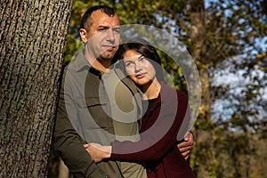 Beautiful young couple in autumn forest on a sunny day