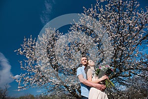 Beautiful young couple dancing and having fun on blue sky background