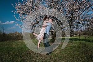 Beautiful young couple dancing and having fun on blue sky background