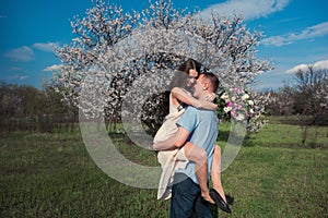 Beautiful young couple dancing and having fun on blue sky background