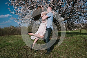 Beautiful young couple dancing and having fun on blue sky background