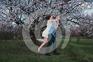 Beautiful young couple dancing and having fun on blue sky background