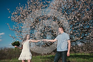 Beautiful young couple dancing and having fun on blue sky background