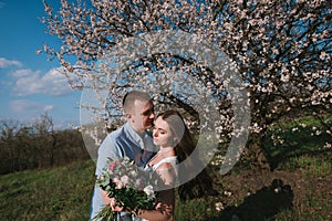 Beautiful young couple dancing and having fun on blue sky background