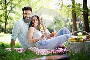 Beautiful young couple enjoying in a good mood and picnic day