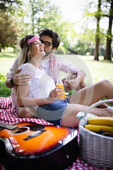 Beautiful young couple enjoying in a good mood and picnic day