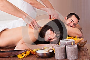 Beautiful young couple enjoying massage