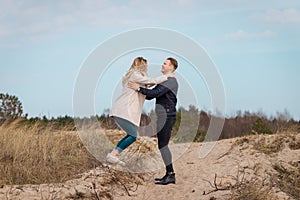 Beautiful young couple enjoying spring beach vacation, playful on sunny blue sky outdoors.having fun and being active