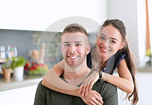 Beautiful young couple is having fun in kitchen at home
