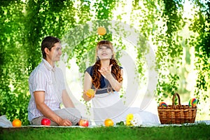 Beautiful Young Couple Having Fun. Picnic in Countryside. Happy