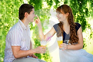 Beautiful Young Couple Having Fun. Picnic in Countryside. Happy