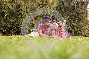 Beautiful young couple having picnic happy about nice weather
