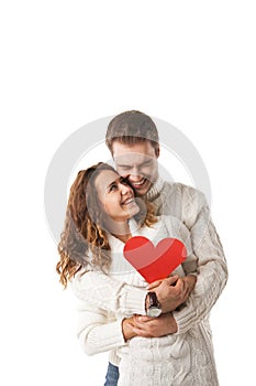 Beautiful young couple holding a red heart