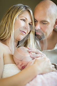 Beautiful Young Couple Holding Their Newborn Baby Girl
