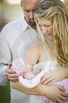 Beautiful Young Couple Holding Their Newborn Baby Girl