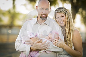 Beautiful Young Couple Holding Their Newborn Baby Girl