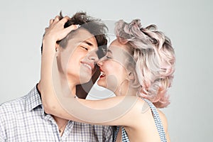 Beautiful young couple hugging and holding each other in studio. Beautiful young smiling couple in love. Love. Portrait