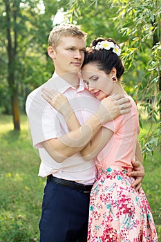 Beautiful young couple hugging in nature