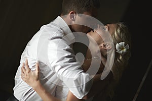 Beautiful young couple kissing with emotional embrace.