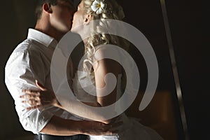 Beautiful young couple kissing with emotional embrace.