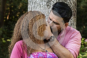 Beautiful young couple kissing in the park