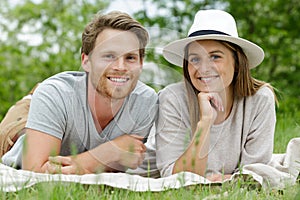 Beautiful young couple lay on grass