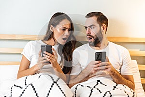 Beautiful young couple laying together in bed