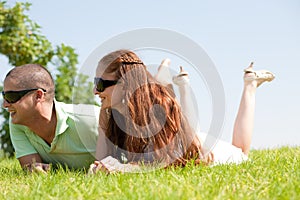 Beautiful young Couple lie down on grass