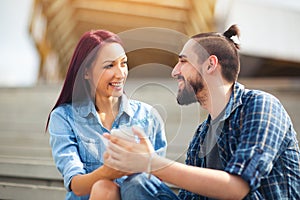 Beautiful young couple looking at the mobile phone together