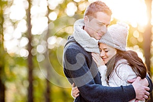 Beautiful young couple in love, hugging. Sunny autumn nature.
