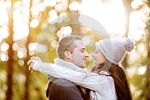 Beautiful young couple in love, hugging. Sunny autumn nature.