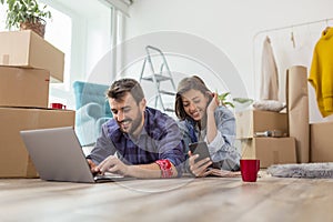 Couple searching for apartment redecoration ideas while moving in together photo