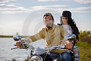 Beautiful young couple with a motorcycle