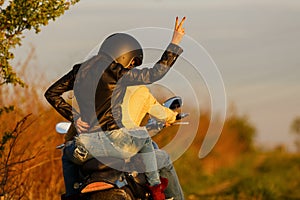 Beautiful young couple with a motorcycle