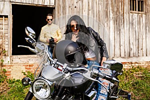 Beautiful young couple with a motorcycle