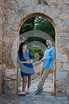 Beautiful young couple near the ancient walls of the old castle