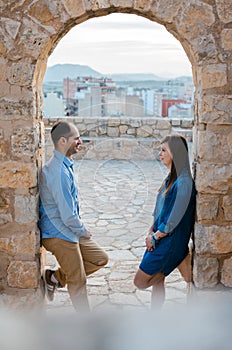 Beautiful young couple near the ancient walls of the old castle