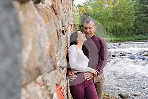 beautiful young couple posing near the river