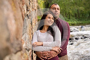 beautiful young couple posing near the river