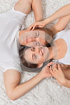 Beautiful young couple on soft bed in morning