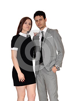 A beautiful young couple standing smiling in the studio