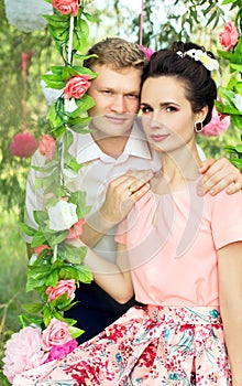 Beautiful young couple on a swing