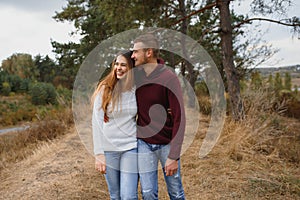 Beautiful young couple walking in autumn park