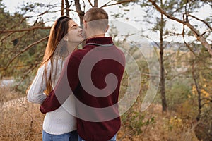 Beautiful young couple walking in autumn park