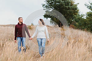 Beautiful young couple walking in autumn park